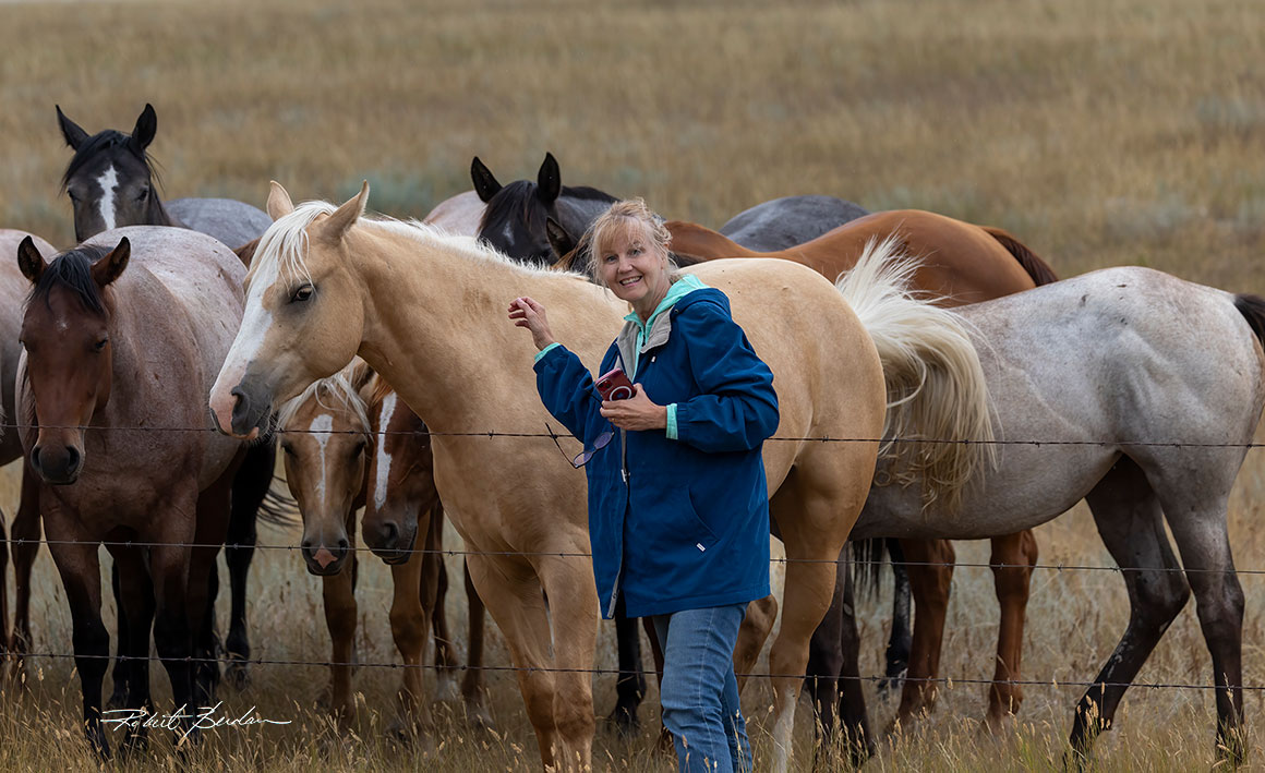 Donna and with horses found next to a fence in Grasslands National Park by Robert Berdan ©