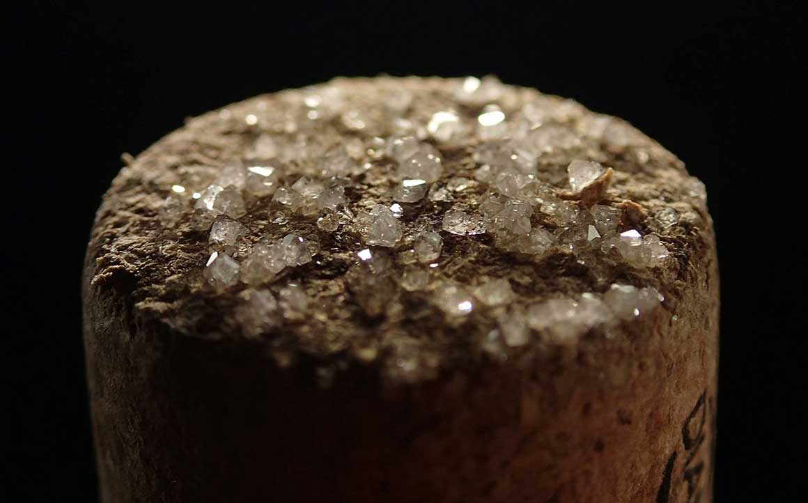 Tartrate crystals on a cork of a white Chardonnay wine. 