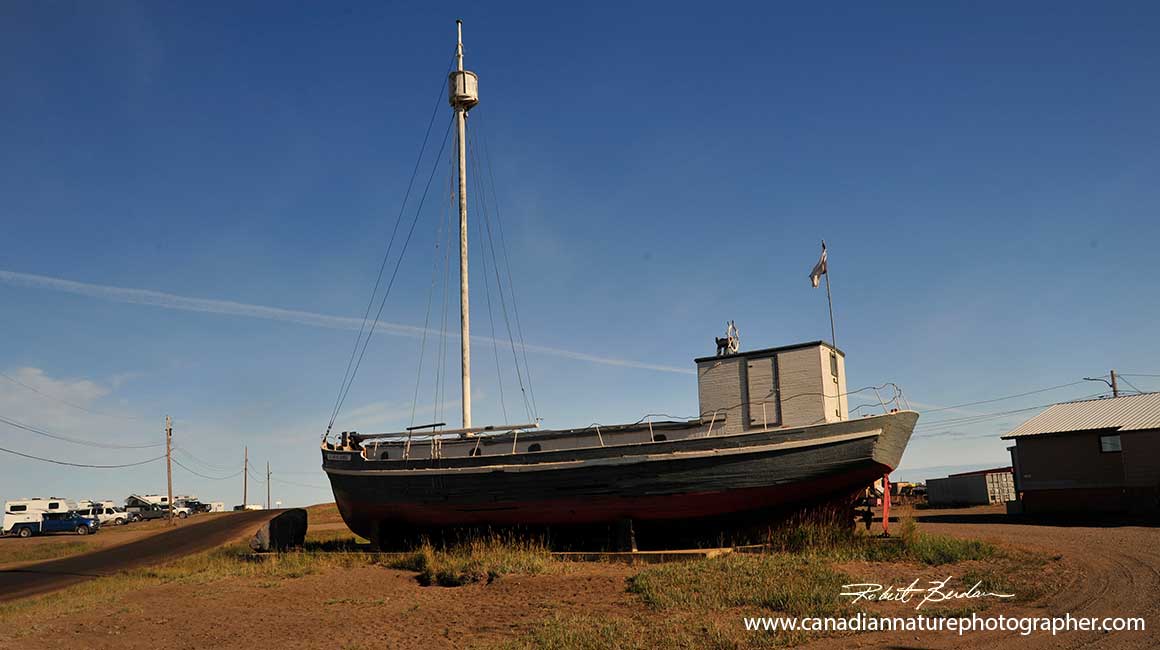 Boat in repair in Tuktoyaktuk by Robert Berdan 