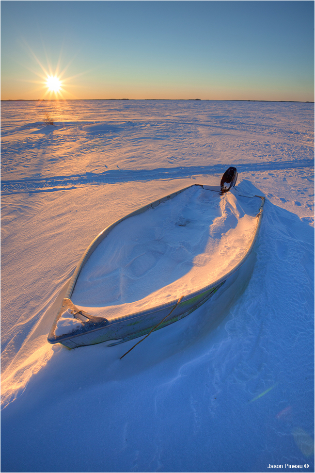 Boat in winter on shores of Lac Le Martre, NWT by Jason Pineau ©