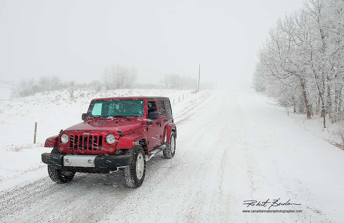 Four door jeep on winter road - used for photography 