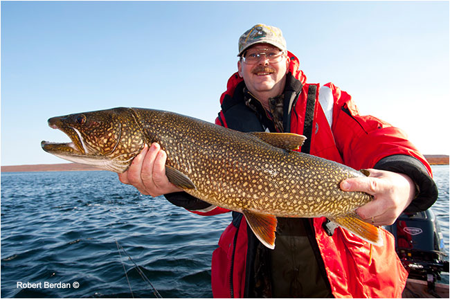 Egun Wuth holds Lake trout caught at point lake by Robert Berdan ©