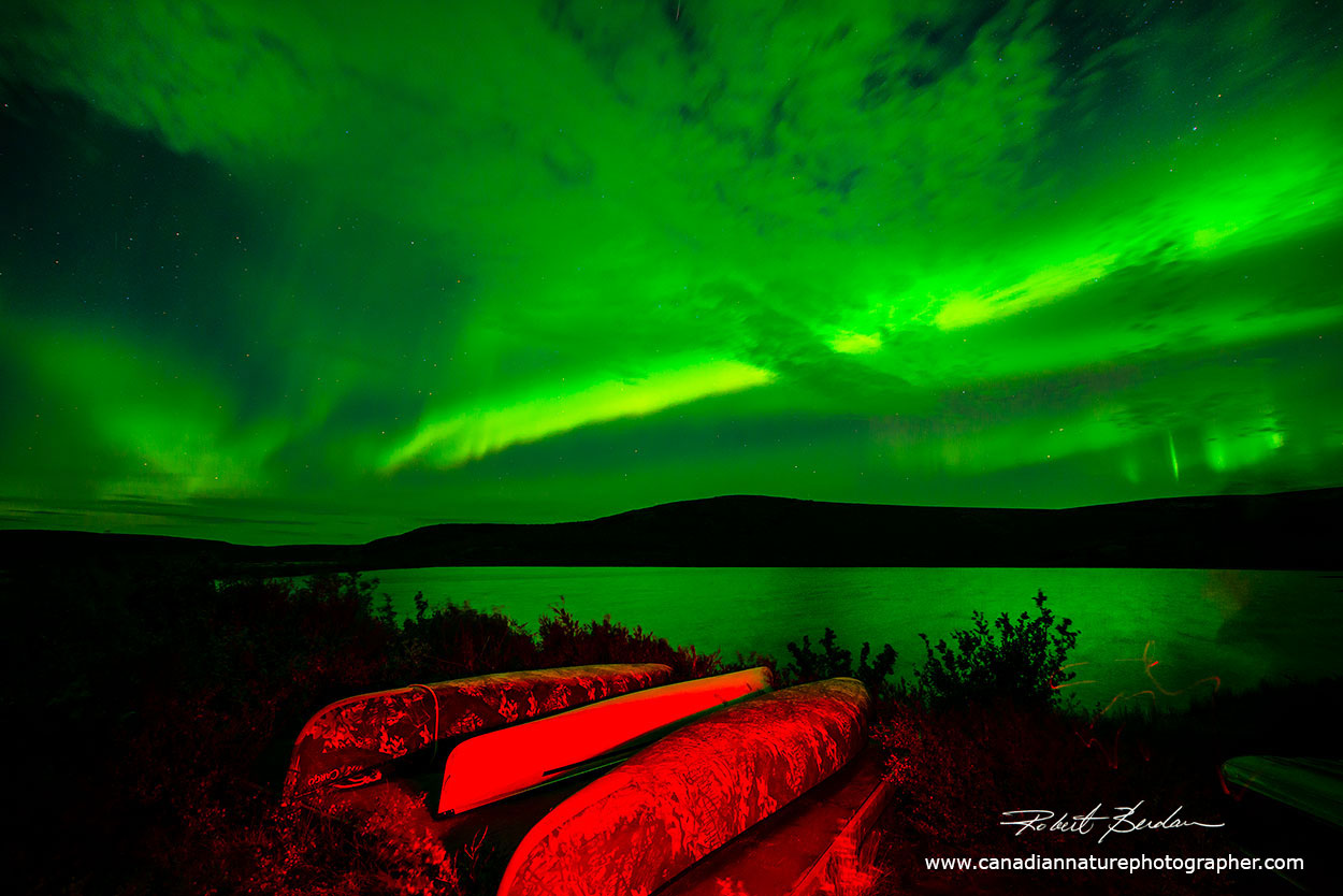 I used a red light to light-paint the canoes with the Aurora in the background by Robert Berdan ©