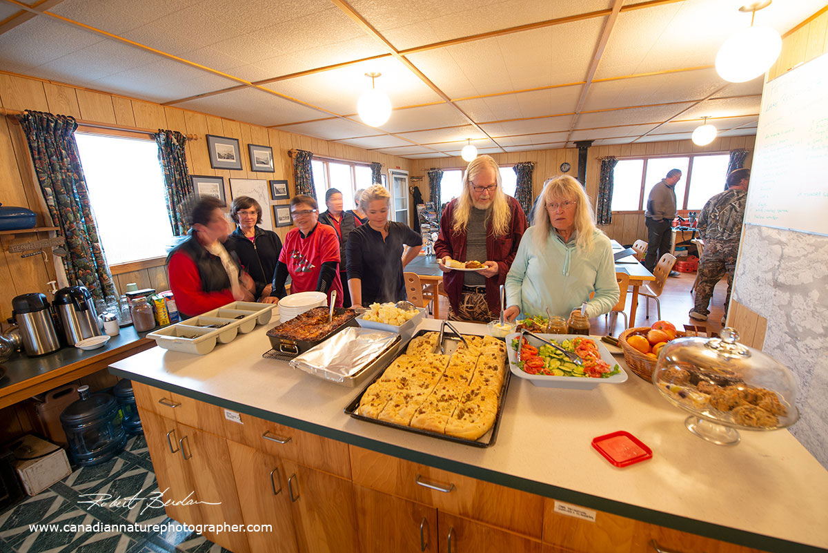Guests line up for food at Point Lake Lodge by Robert Berdan ©