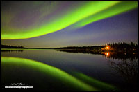 Aurora borealis and cabin Pontoon Lake, Yellowknife, NT by Robert Berdan
